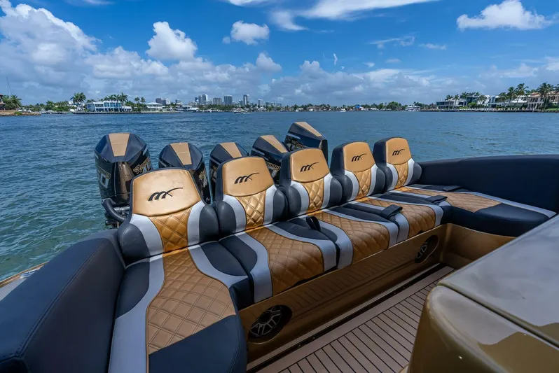 Perla Bianca II Yacht Photos Pics Luxury seating on 2023 Midnight Express 43 Open boat with scenic waterfront view.