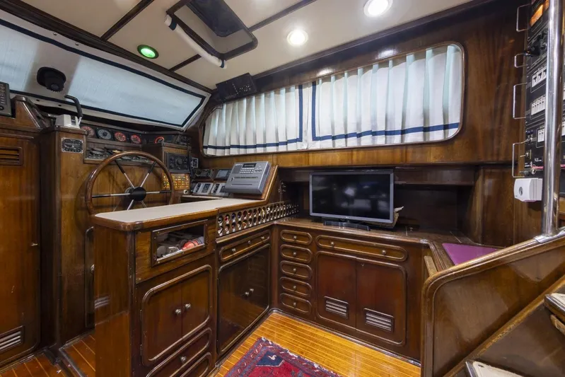  Yacht Photos Pics Interior of 1982 Benetti Sail Division 16m Motorsailer with wooden helm and modern navigation equipment.