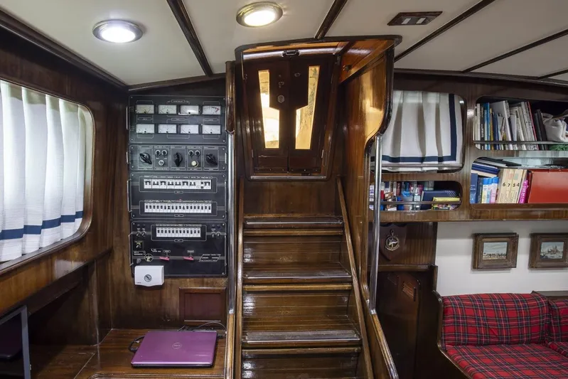  Yacht Photos Pics Interior of 1982 Benetti Sail Division 16m Motorsailer with wooden stairs and control panel.