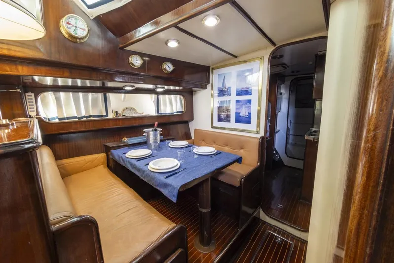  Yacht Photos Pics Luxurious interior of 1982 Benetti Sail Division 16m Motorsailer with elegant dining area.