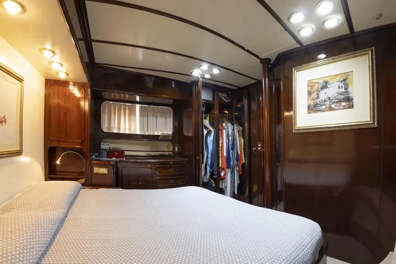  Yacht Photos Pics Luxurious cabin interior of 1982 Benetti Sail Division 16m Motorsailer with elegant wood finishes.