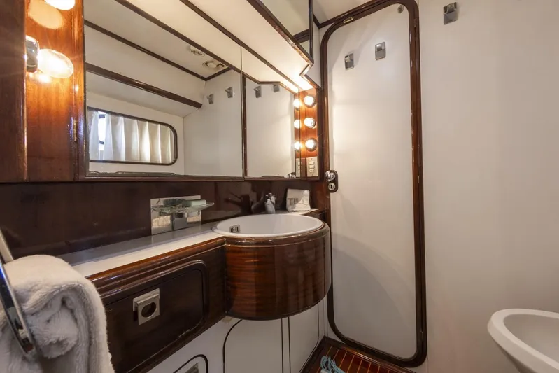  Yacht Photos Pics Luxurious bathroom in 1982 Benetti Sail Division 16m Motorsailer, featuring elegant wood finishes.