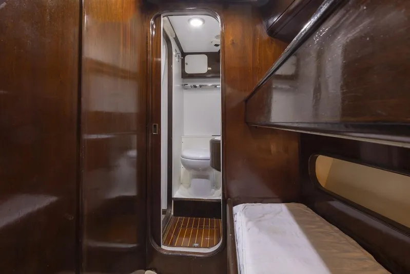  Yacht Photos Pics Interior of 1982 Benetti Sail Division 16m Motorsailer with wooden finish and compact bathroom.