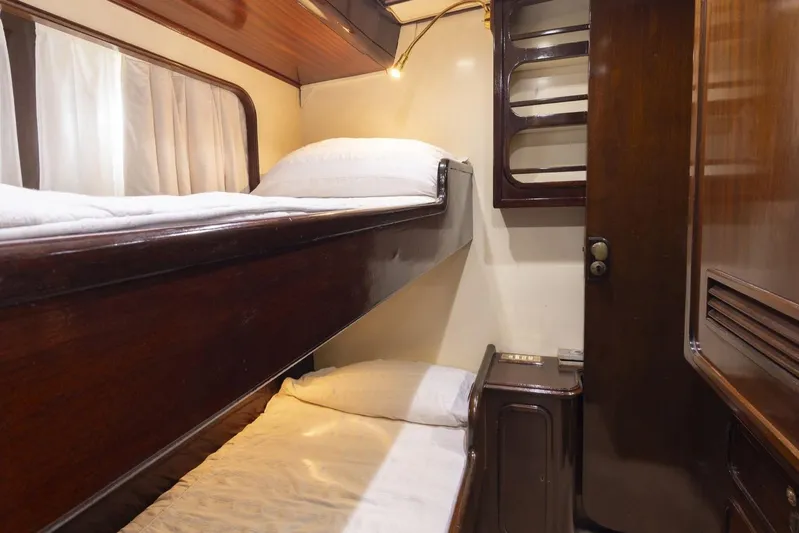  Yacht Photos Pics Interior of 1982 Benetti Sail Division 16m Motorsailer with wooden bunk beds and cozy lighting.