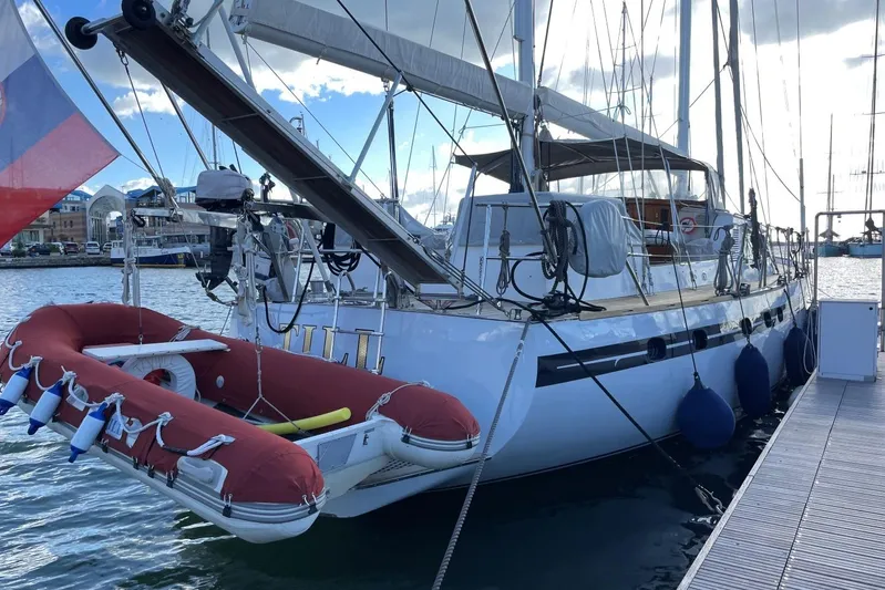  Yacht Photos Pics 1982 Benetti Sail Division 16m Motorsailer docked with red dinghy and blue fenders.