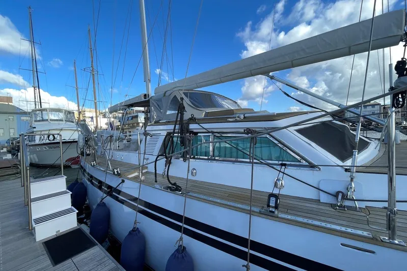  Yacht Photos Pics 1982 Benetti Sail Division 16m Motorsailer docked under blue sky.