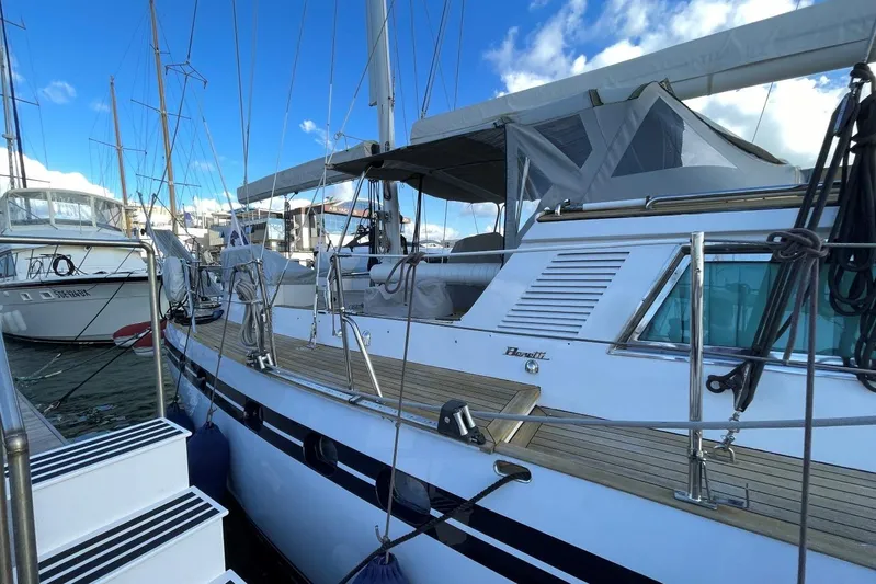  Yacht Photos Pics 1982 Benetti Sail Division 16m Motorsailer docked, showcasing sleek design and spacious deck.