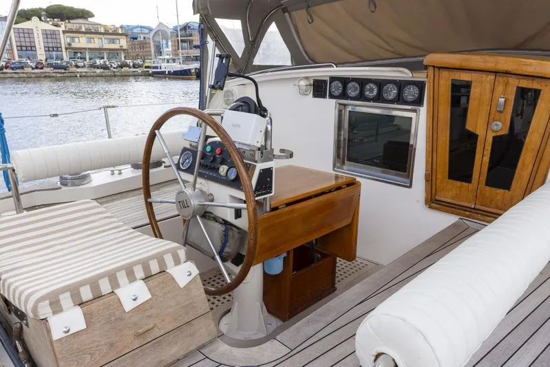  Yacht Photos Pics 1982 Benetti Sail Division 16m Motorsailer cockpit with wooden wheel and navigation instruments.
