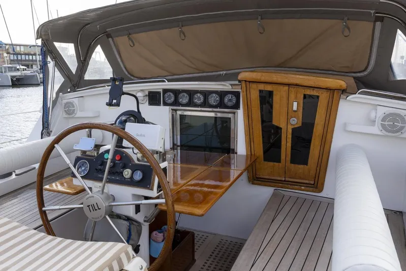  Yacht Photos Pics Cockpit of 1982 Benetti Sail Division 16m Motorsailer with wooden steering wheel and navigation instruments.