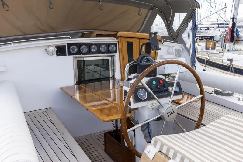 Yacht Photos Pics Cockpit of 1982 Benetti Sail Division 16m Motorsailer with wooden steering wheel and navigation instruments.