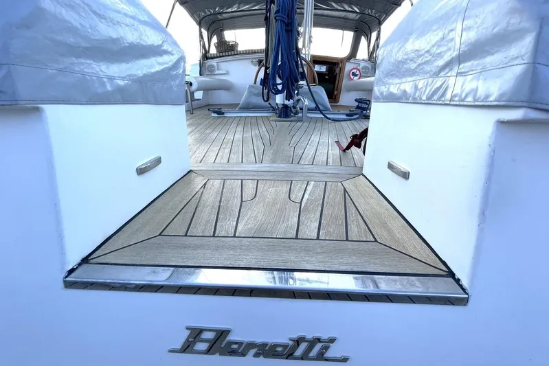  Yacht Photos Pics 1982 Benetti Sail Division 16m Motorsailer deck with teak flooring and covered seating area.