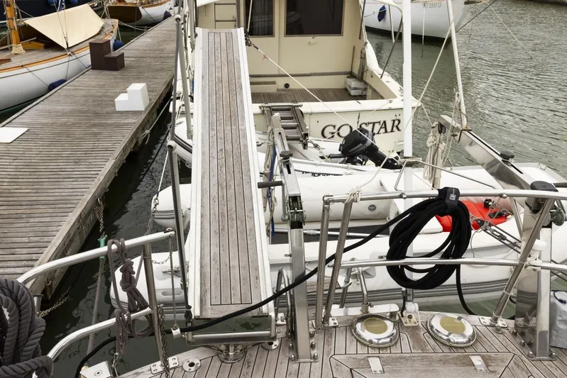 Yacht Photos Pics 1982 Benetti Sail Division 16m Motorsailer docked with gangway and dinghy visible.