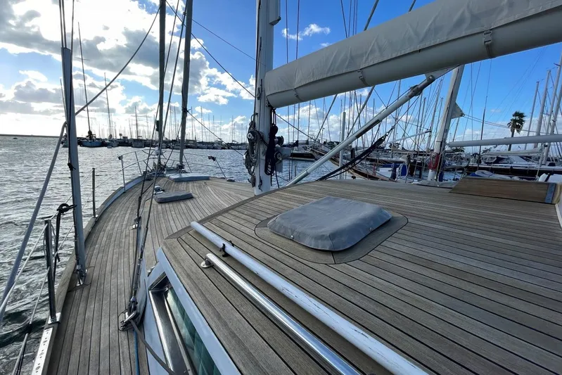  Yacht Photos Pics 1982 Benetti Sail Division 16m Motorsailer on calm waters, showcasing sleek wooden deck design.