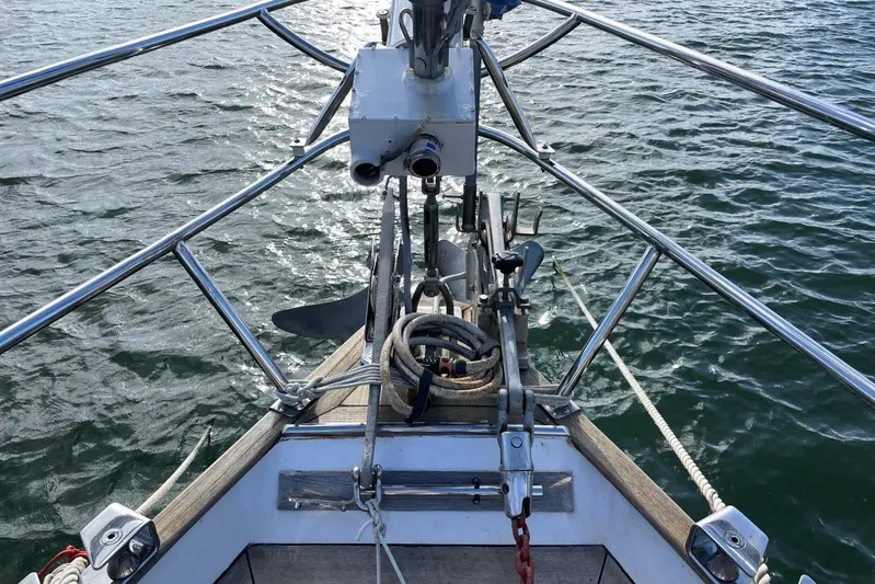  Yacht Photos Pics 1982 Benetti Sail Division 16m Motorsailer bow with ropes and anchor on water.