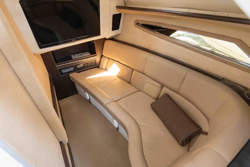  Yacht Photos Pics Luxurious interior of 2013 Cobalt 336 boat with beige seating and TV.
