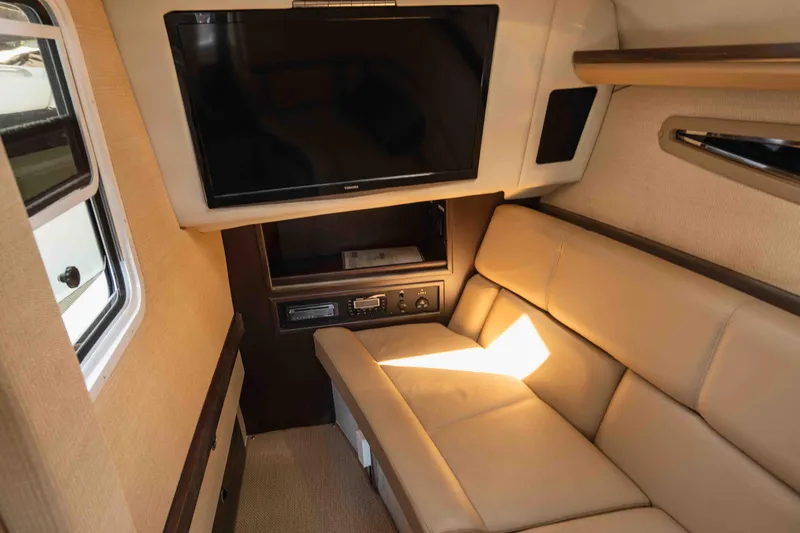  Yacht Photos Pics Interior of 2013 Cobalt 336 boat with beige seating and mounted TV.