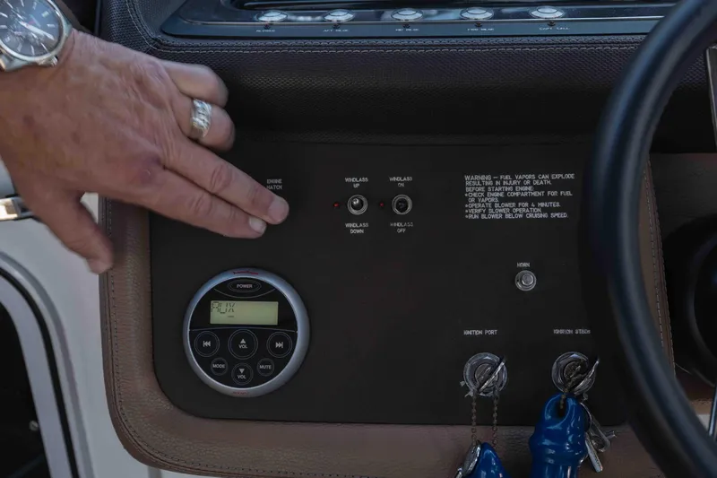  Yacht Photos Pics Control panel of a 2013 Cobalt 336 boat with hand adjusting settings.