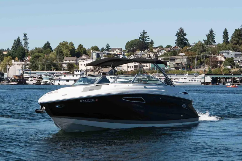  Yacht Photos Pics 2013 Cobalt 336 boat cruising on a scenic lake with houses in the background.