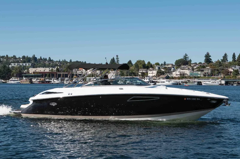  Yacht Photos Pics 2013 Cobalt 336 boat cruising on a lake with a scenic shoreline backdrop.