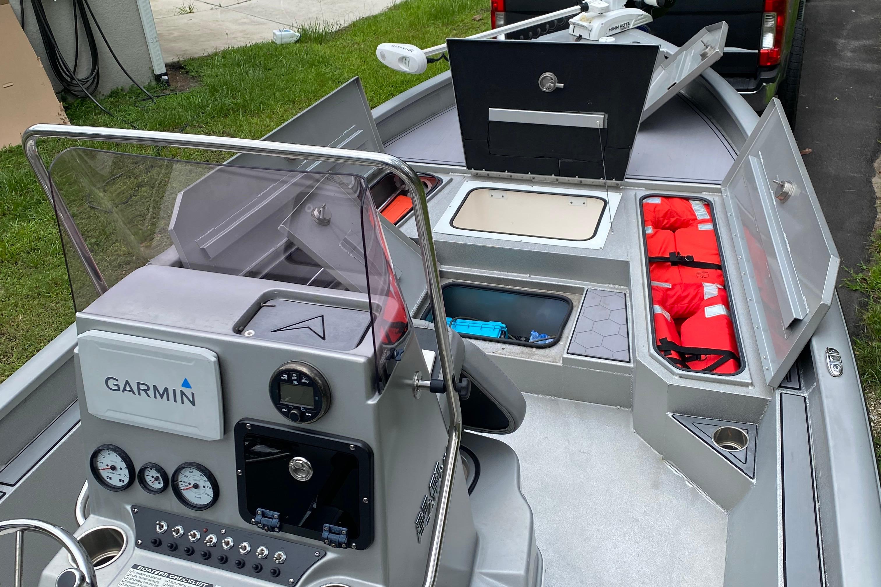 2021 Avid 23 FS Magnum boat interior with Garmin navigation and storage compartments.