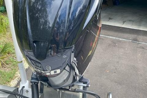 2021 Avid 23 FS Magnum boat with powerful outboard motor in driveway.