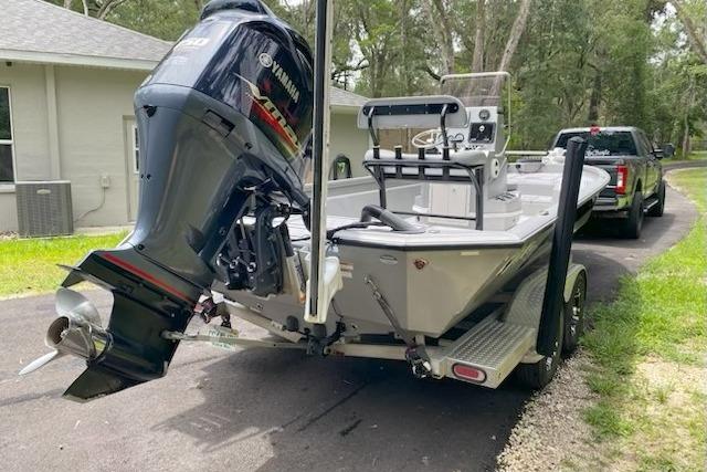 2021 Avid 23 FS Magnum boat with Yamaha outboard motor on trailer.