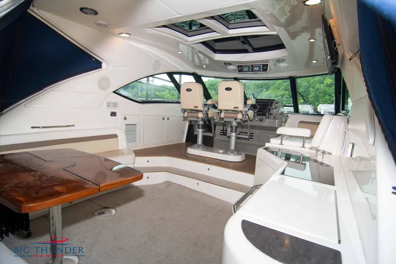  Yacht Photos Pics Interior of a 2013 Sea Ray 540 Sundancer yacht with helm and seating area.