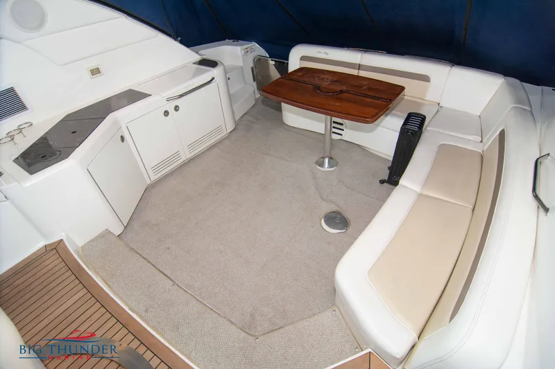  Yacht Photos Pics Interior seating area of a 2013 Sea Ray 540 Sundancer yacht with a wooden table.