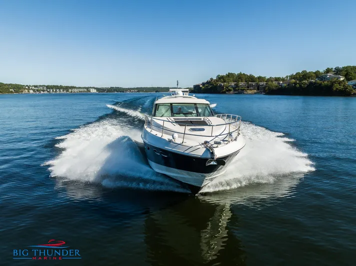  Yacht Photos Pics 2013 Sea Ray 540 Sundancer cruising on a serene lake.