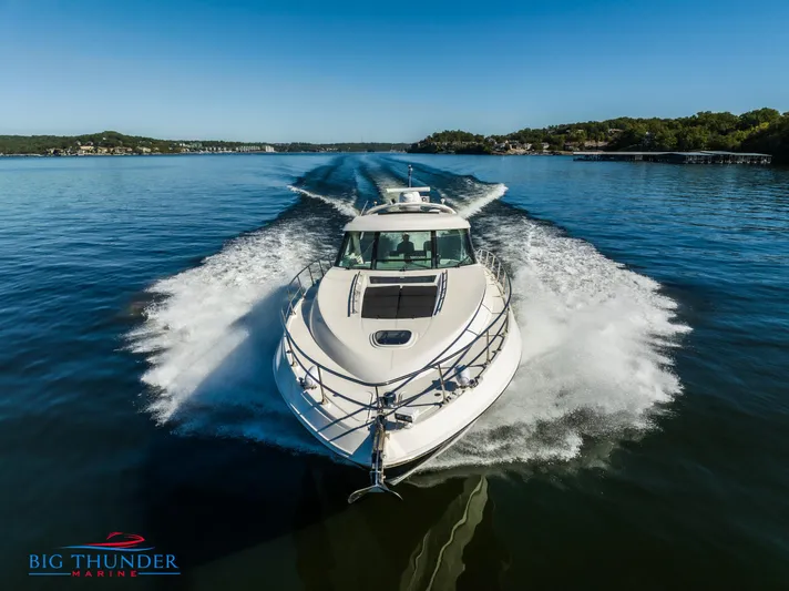  Yacht Photos Pics 2013 Sea Ray 540 Sundancer cruising on a clear lake, creating a dynamic wake.