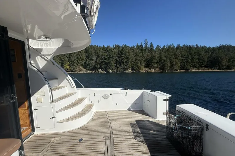  Yacht Photos Pics Royal Pacific 476 Sport Cruiser 2000 on serene lake with forested shoreline.