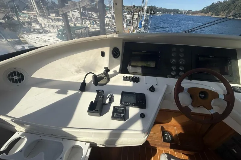  Yacht Photos Pics Cockpit of 2000 Royal Pacific 476 Sport Cruiser with steering wheel and navigation controls.