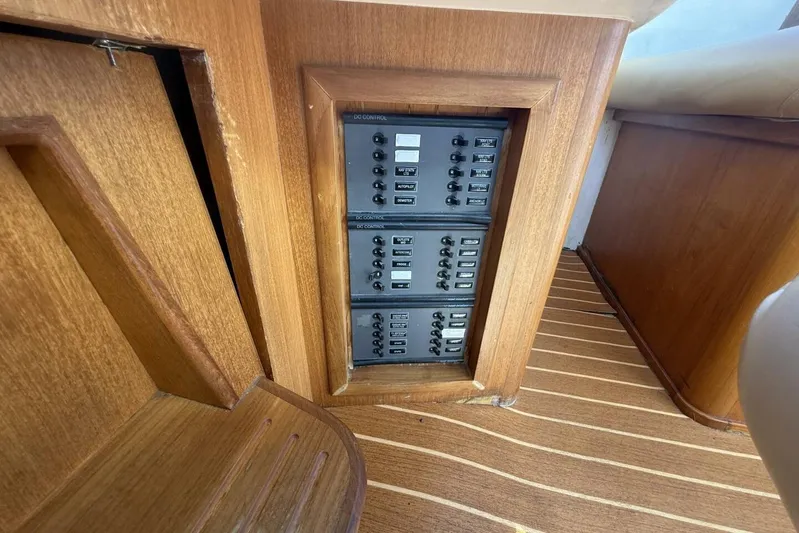  Yacht Photos Pics Electrical control panel on 2000 Royal Pacific 476 Sport Cruiser, featuring wooden interior design.