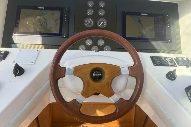  Yacht Photos Pics Steering wheel and dashboard of 2000 Royal Pacific 476 Sport Cruiser with navigation screens.