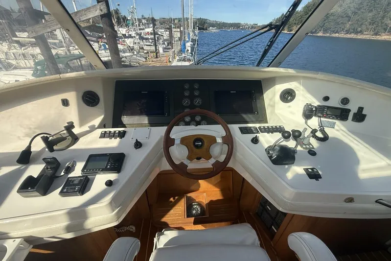  Yacht Photos Pics Cockpit of 2000 Royal Pacific 476 Sport Cruiser with steering wheel and navigation controls.