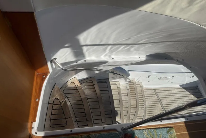  Yacht Photos Pics Staircase on 2000 Royal Pacific 476 Sport Cruiser with wooden steps and metal handrail.