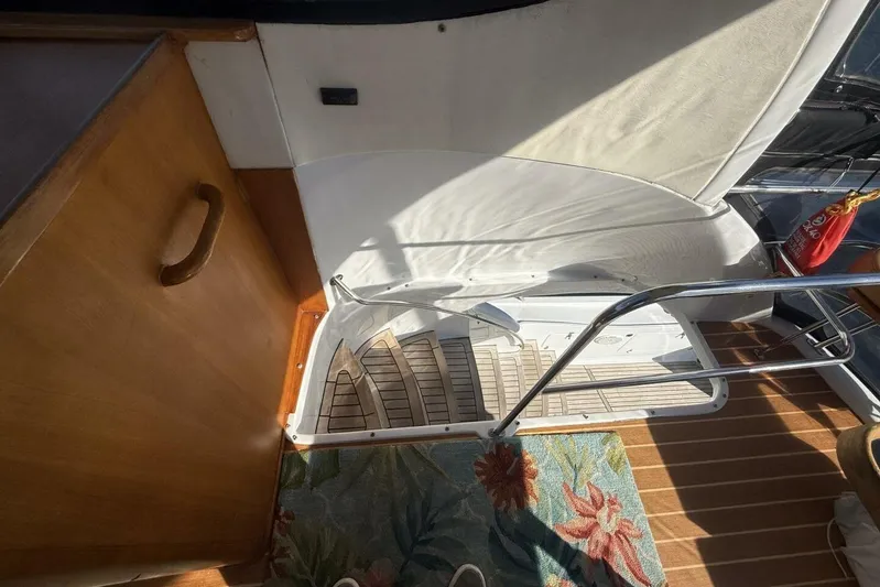  Yacht Photos Pics Interior stairs of 2000 Royal Pacific 476 Sport Cruiser with wooden and floral details.