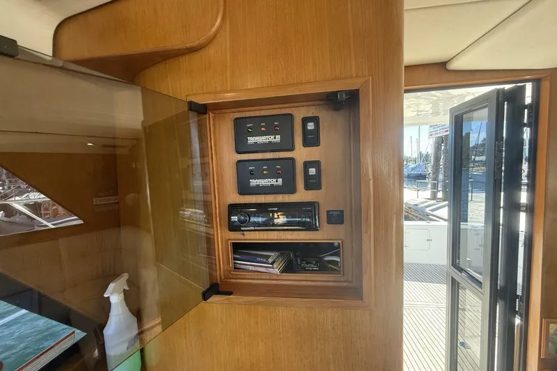  Yacht Photos Pics Control panel inside 2000 Royal Pacific 476 Sport Cruiser yacht, featuring wood finish and marina view.