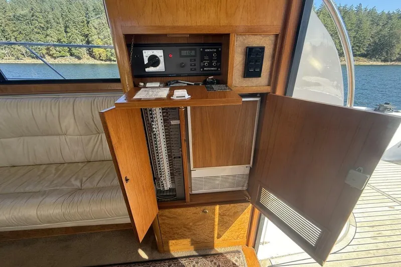  Yacht Photos Pics Control panel inside 2000 Royal Pacific 476 Sport Cruiser, featuring wood cabinetry and lake view.