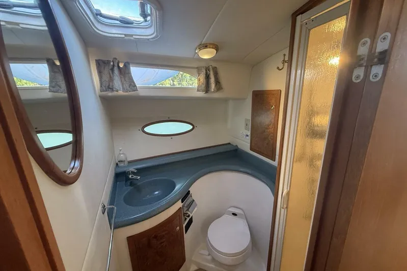  Yacht Photos Pics Bathroom interior of 2000 Royal Pacific 476 Sport Cruiser with sink and toilet.