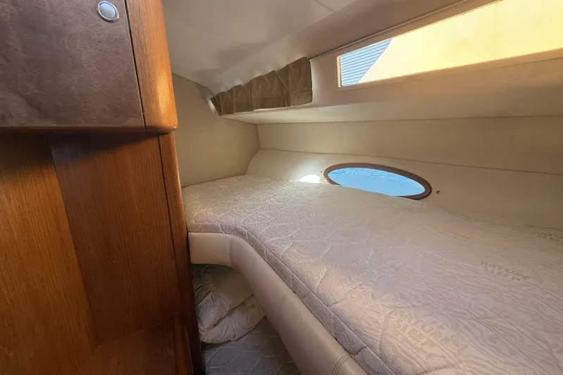  Yacht Photos Pics Cozy cabin interior of 2000 Royal Pacific 476 Sport Cruiser with porthole and wooden accents.