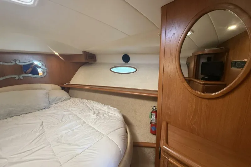  Yacht Photos Pics Interior cabin of 2000 Royal Pacific 476 Sport Cruiser with bed and wooden furnishings.