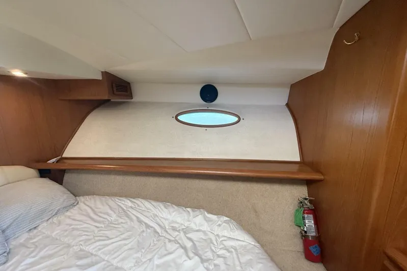  Yacht Photos Pics Cozy cabin interior of 2000 Royal Pacific 476 Sport Cruiser with porthole and fire extinguisher.