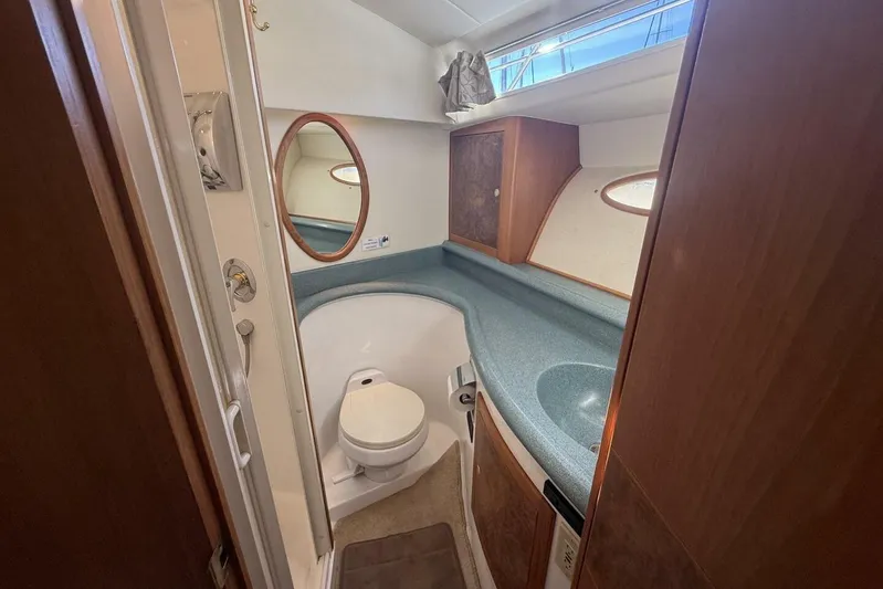  Yacht Photos Pics Bathroom interior of 2000 Royal Pacific 476 Sport Cruiser with sink and toilet.
