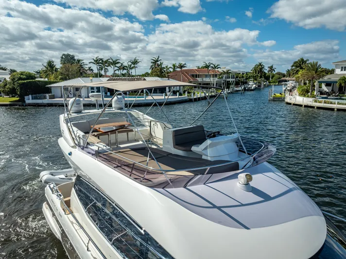Miss Zoe Yacht Photos Pics Prestige 500 Fly 2014 yacht cruising on a sunny day in a scenic canal.