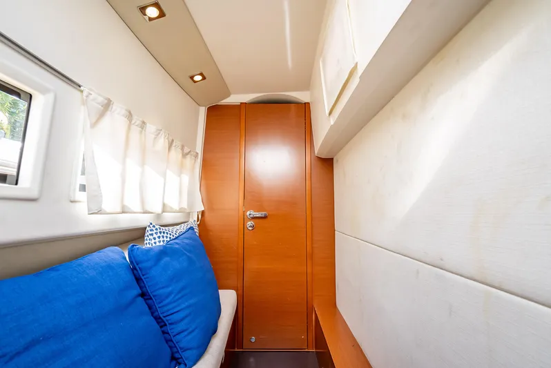 Miss Zoe Yacht Photos Pics Interior of 2014 Prestige 500 Fly yacht with blue cushions and wooden door.