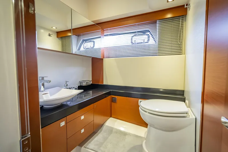 Miss Zoe Yacht Photos Pics Luxurious bathroom in 2014 Prestige 500 Fly yacht with modern fixtures and wood accents.
