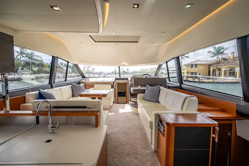 Miss Zoe Yacht Photos Pics Luxurious interior of a 2014 Prestige 500 Fly yacht with modern furnishings and panoramic windows.