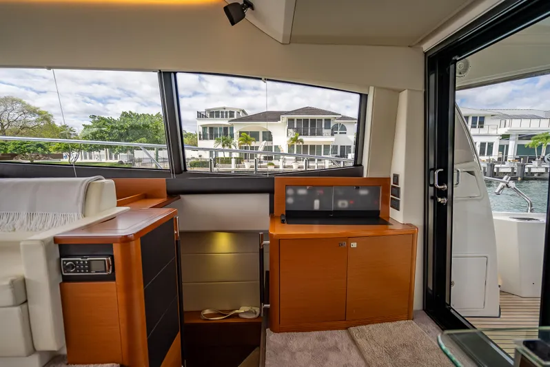 Miss Zoe Yacht Photos Pics Interior of 2014 Prestige 500 Fly yacht with modern wood cabinetry and large windows.