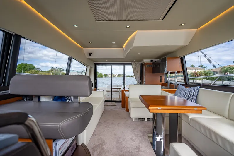 Miss Zoe Yacht Photos Pics Luxurious interior of 2014 Prestige 500 Fly yacht with modern seating and dining area.